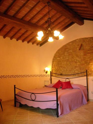 a bedroom with a bed and a ceiling at Antico Casolare in San Gimignano
