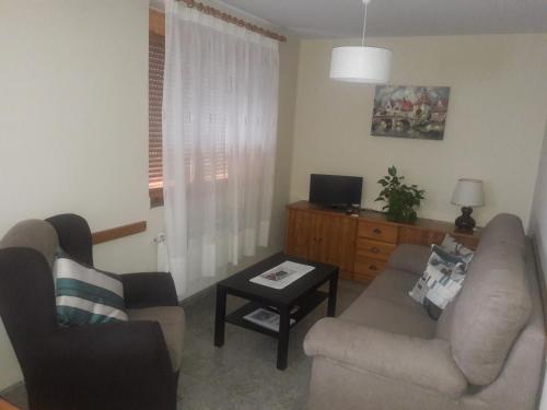 a living room with a couch and a table at Apartamentos Casa Borja in Salinas de Bielsa