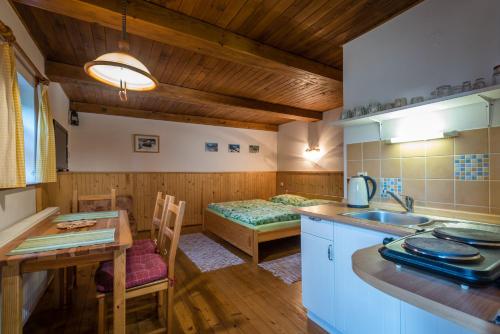 a kitchen with a table and a bed in a room at Montana Bobrovec in Bobrovec