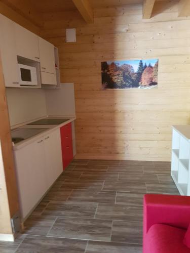 a small kitchen with wooden walls and a counter top at Lorica Suite Lago in Lorica