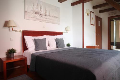 1 dormitorio con 1 cama grande con almohadas blancas en Sobe Bimbo, en Zaprešić