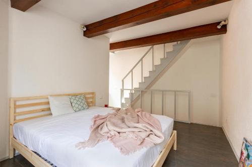 a bedroom with a bed and a staircase at Cedro Apartment - Smart Holiday in Mantova