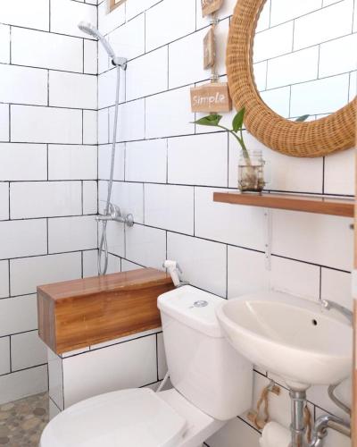 a bathroom with a toilet and a sink at Boscha Villas 101 in Bandung