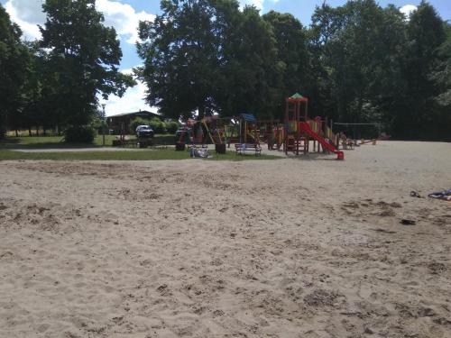 a playground in a park with a sand field at Zajazd U Doktora in Lubrza