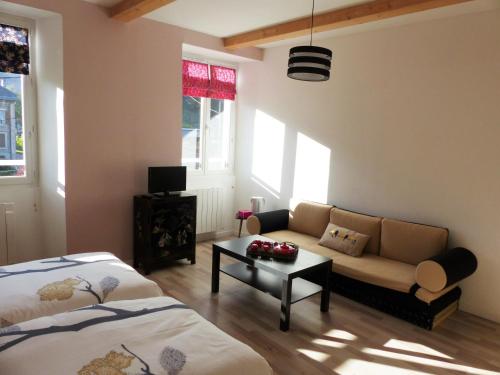 a living room with two beds and a couch at Montagne attitude in Jausiers