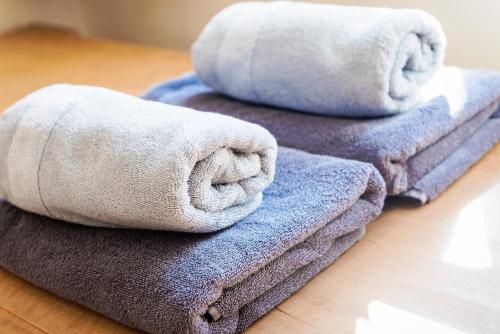 a pile of towels sitting on top of a table at Villa Anna Bad Goisern am Hallstättersee in Bad Goisern