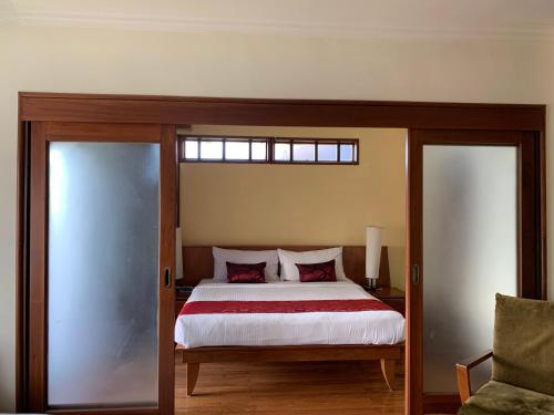 a bedroom with a large bed and a window at SEA VILLA LANGKAWI LAGOON in Pantai Cenang