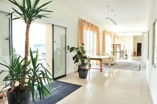 a living room with potted plants on the floor at Eisenbock's Strasser Hof in Strass