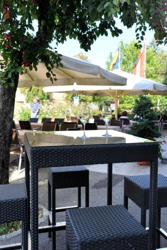 a table with two wine glasses and an umbrella at Eisenbock's Strasser Hof in Strass