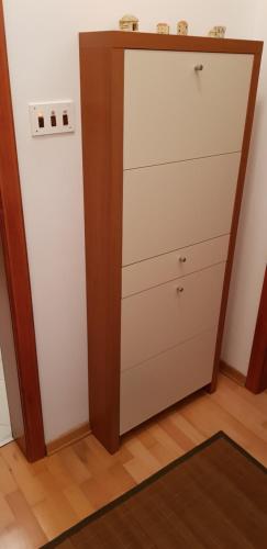 a closet with a dresser in a room at Apartmani Gaj in Malinska