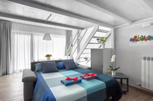 a bedroom with a large blue bed with two bags on it at Milky House Milan in Milan