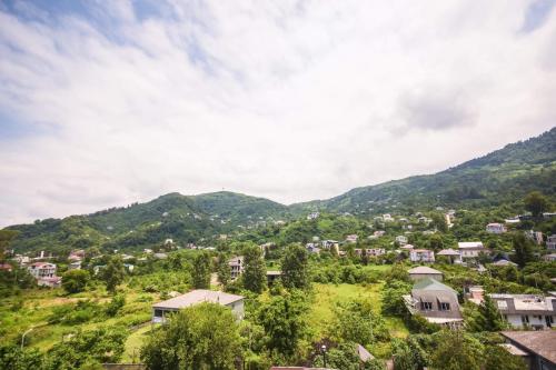 a view of a small town in the mountains at Hotel Otsneba in Kvariati