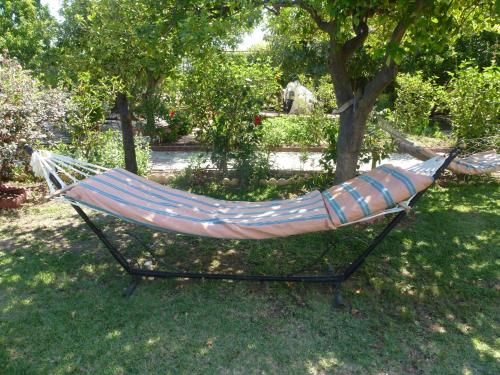 a hammock sitting in the grass in a yard at Lapida Garden in Kérynia