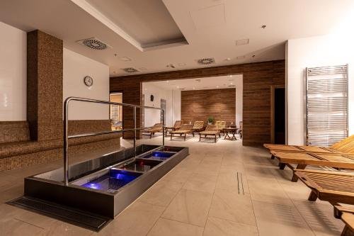 a lobby with a hot tub in the middle at Rezidence Fontána in Teplice