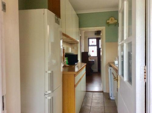 a kitchen with a white refrigerator in a room at Gateway House in Didcot