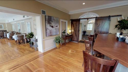 a living room with a table and a dining room at Simsbury 1820 House in Simsbury