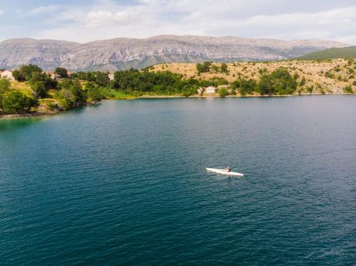 a person in a boat on a lake at Holiday home Marija in Vrlika
