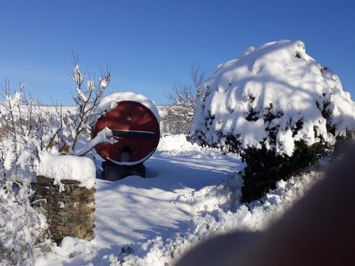 a snow covered instrument sitting in the snow at Agriturismo Cascina Binelli in Dogliani