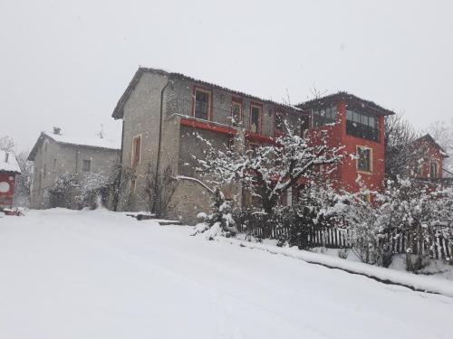 a snow covered yard in front of a house at Agriturismo Cascina Binelli in Dogliani