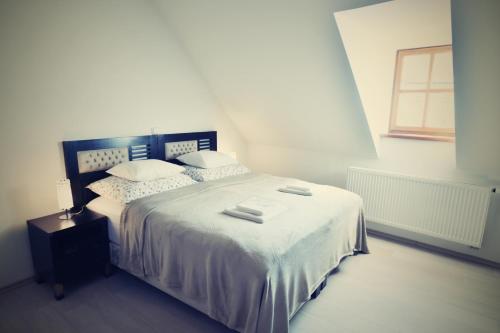 a bedroom with a bed with two towels on it at Bed&Bike Prachatice in Prachatice