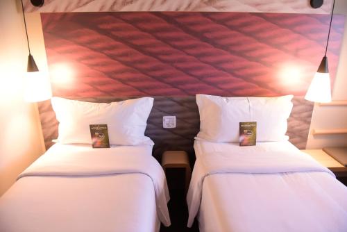 Cama o camas de una habitación en Hotel Ibis Tatui