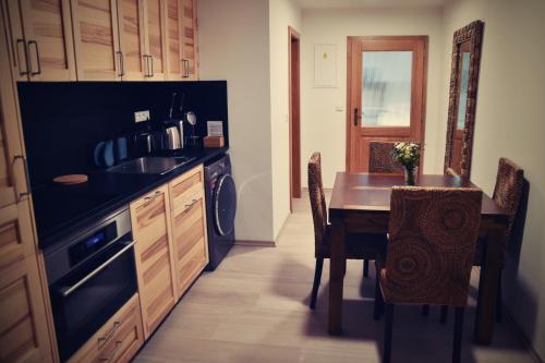 a kitchen with a table and a dining room at Bed&Bike Prachatice in Prachatice