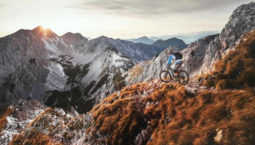 a man riding a bike on a mountain trail at Snežak (Snowman) 2 in Bohinj