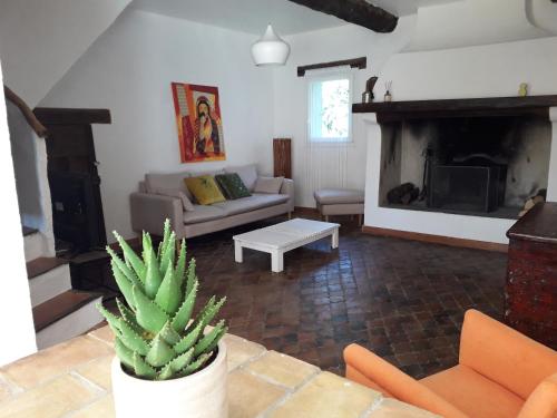 a living room with a couch and a fireplace at BANDOL Maison de Campagne in Bandol