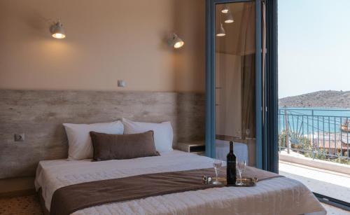 a bedroom with a bed and a large window at Vivari Acta in Vivari