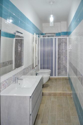 a bathroom with a tub and a toilet and a sink at Clotilde in Bisceglie