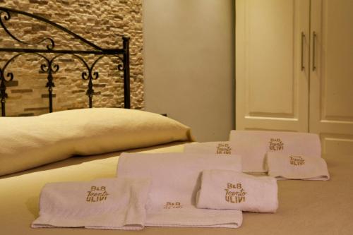 a bed with three folded towels on top of it at B&B 7Cento Ulivi in Valderice
