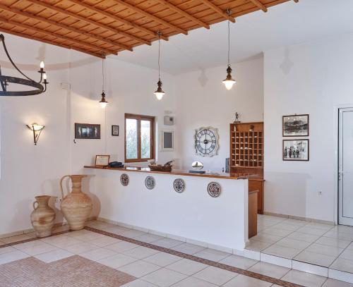 a kitchen with white walls and a counter with vases at Lindos Athena in Líndos