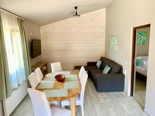 a living room with a table and a couch at Kalabash Apartments in Sovata