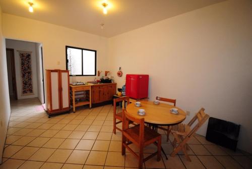 a kitchen with a table and chairs and a red refrigerator at Casa Gecko in Oaxaca City