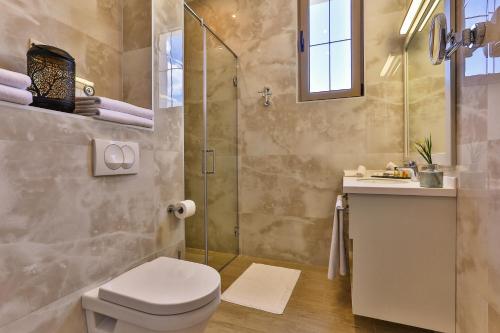 a bathroom with a toilet and a shower at Avanti Hotel & Spa in Budva