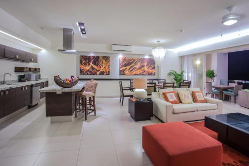a living room and kitchen with a couch and a table at Marival Distinct All-Suites & World Spa - Handwritten Collection in Nuevo Vallarta 