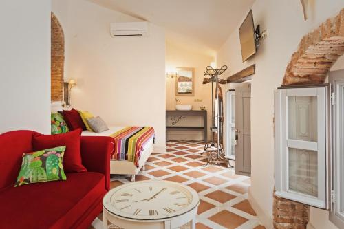 a living room filled with furniture and a couch at EL TORREON 109 CHARMING B&B - Recomendado Adultos in Frigiliana