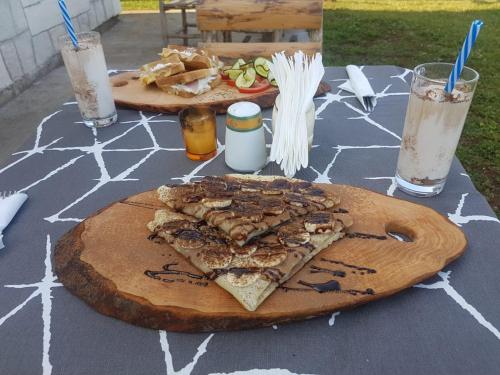 a table with two slices of pizza on top at Belette Apartments & Park in Nikšić