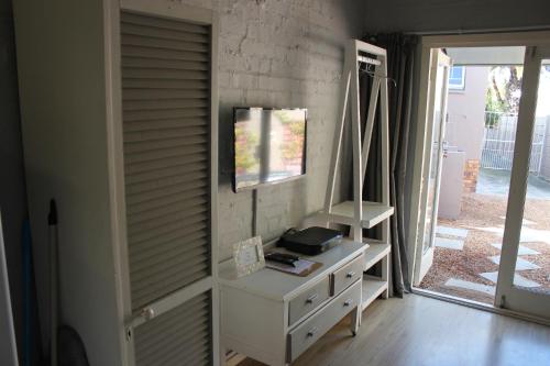 a room with a white dresser and a window at 25 on Fitzpatrick in Parow