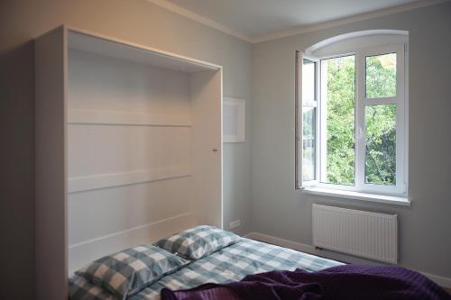 sypialnia z łóżkiem i oknem w obiekcie Apartament Terra Pia w Poznaniu
