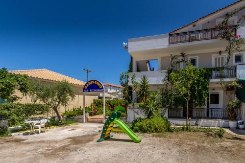a playground in front of a building with a slide at Thetis in Alikanas