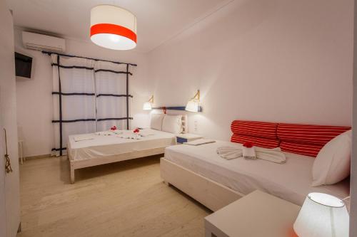 a white room with two beds and a couch at Thetis in Alikanas