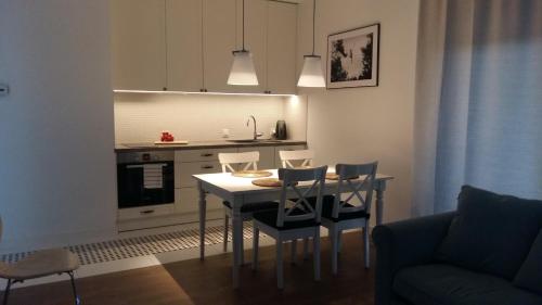a kitchen with a table and chairs in a room at Hel Amber Apart in Hel
