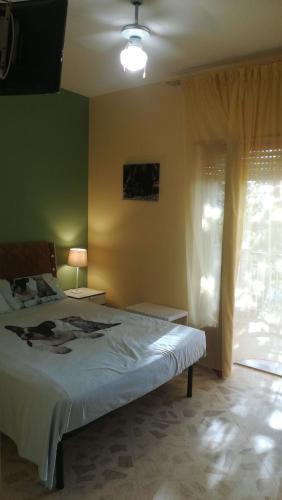 a bedroom with a large bed and a window at Terra Bianca in Trani