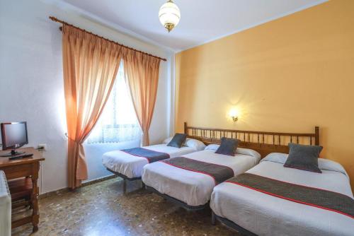 Postel nebo postele na pokoji v ubytování HOTEL RESTAURANTE MOYA