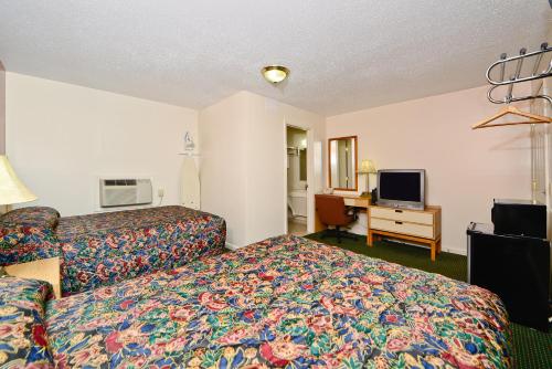 a hotel room with a bed and a television at Best Way Inn in Middlefield