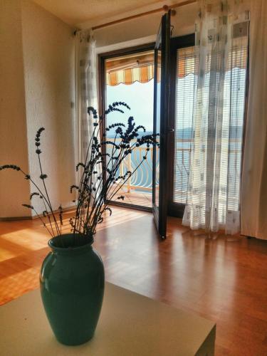 a green vase sitting on a table in a room at Apartment Bellavita Senj in Senj