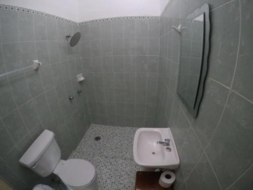 a bathroom with a white toilet and a sink at Casa CheJum Bacalar in Bacalar