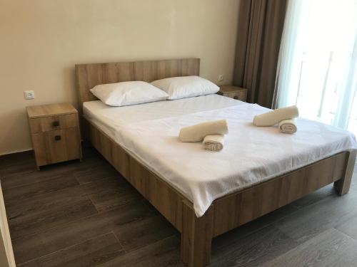 a bedroom with a bed with two towels on it at Hotel CHARLI in Gonio