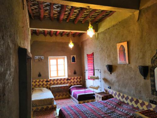 a living room with a bed and a couch at Maison Zouala in Zouala